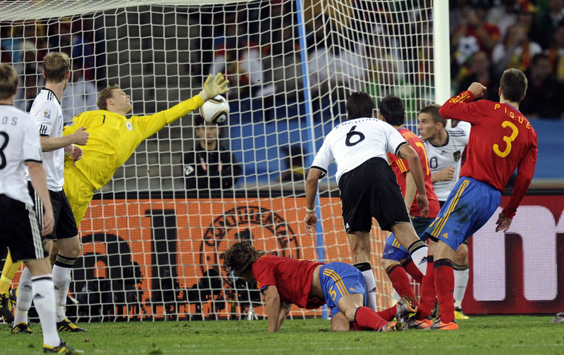 Spain's Carles Puyol, center, on the ground, scores the winning goal past Germany's goalkeeper Manuel Neuer, third left, during the World Cup semifinal today.