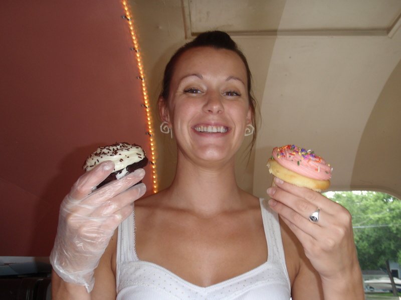 Megan Berry of Hey Cupcake! holds up two cart specialties – a Michael Jackson and a Sweetberry.