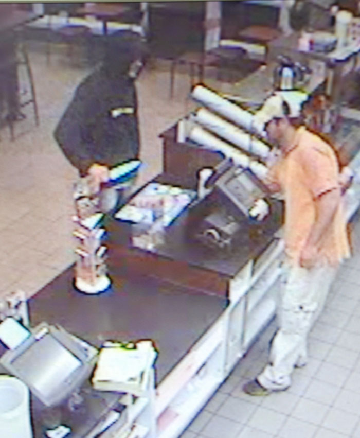 A security camera image taken Monday night at the Dunkin Donuts in Westbrook shows the robbery suspect wielding a knife and demanding money.