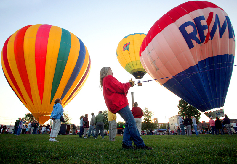 Bonnie Ingrassia pulls a line as she helps launch her daughter's balloon Wandering Winds during the 6 a.m. balloon launch at the Great Falls Balloon Festival at Simard-Payne Memorial Park in Lewiston today.