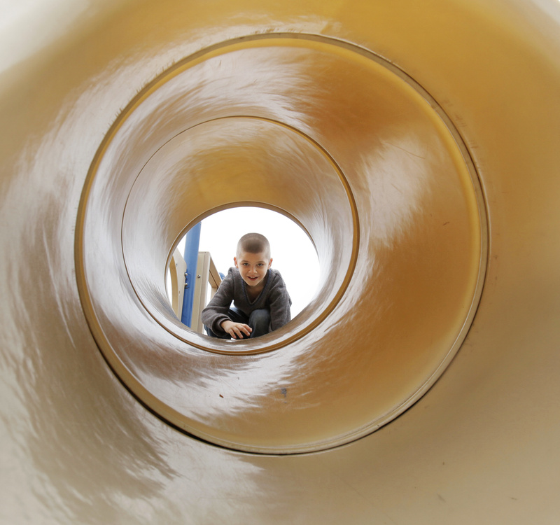 Matthew Absher, 8, looks through a slide while playing at the Eastern Promenade playground in Portland on Monday, August 23, 2010. Absher traveled down from Auburn with his family to spend the day in Portland.