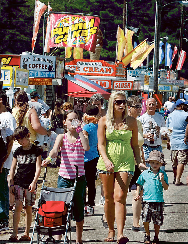 A crowd of all ages navigates the midway at the fair Saturday, partaking of food and beverages that appealed to a crowd of, well, all ages.