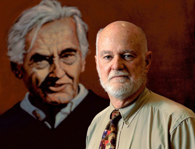 Charlie Clements, director of the Carr Center for Human Rights Policy at Harvard’s Kennedy School, stands in front of a painting of historian Howard Zinn by artist Robert Shetterly of Brooksville.