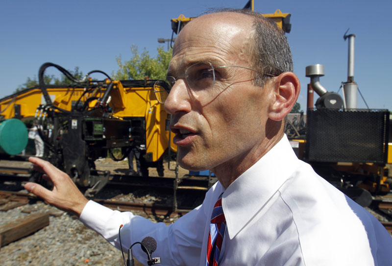 Maine Gov. John Baldacci makes comments as new rail is laid next to old tracks in Brunswick today.