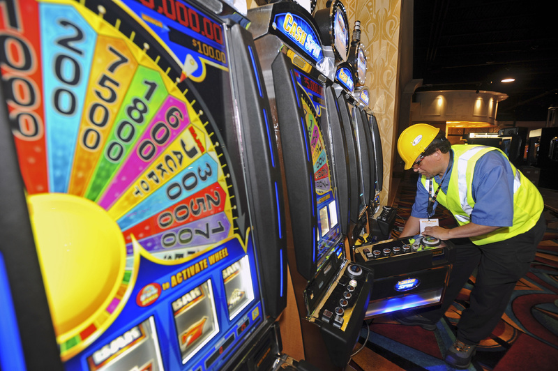 Lincoln Schwitters, a technician with Bally Technology, a maker of slot machines, sets up machines in Perryville, Md., this month. Hollywood Casino in Perryville is expected to open on Sept. 30 as Maryland's first slot casino, joining dozens of others along the Eastern Seaboard. Maine voters will consider in November whether to approve a gambling facility in Oxford County.