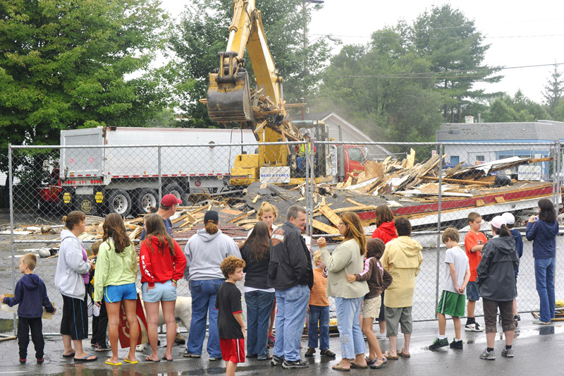 Neighbors and faithful customers of Red's in South Portland watch its demolition this morning.
