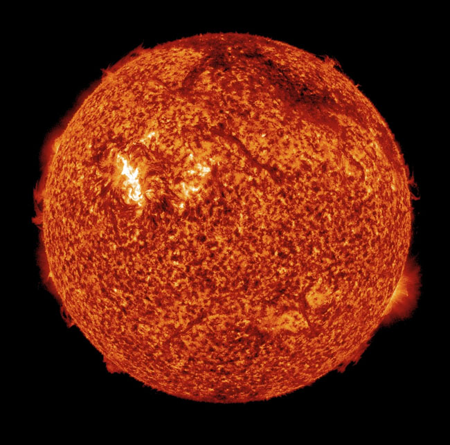 In this X-ray photo provided by NASA, the sun is shown early Sunday morning. The dark arc near the top right edge of the image is a filament of plasma blasting off the surface – part of the coronal mass ejection. The bright region is an unassociated solar flare. When particles from the eruption reach Earth this evening and Wednesday evening, they may trigger a brilliant auroral display known as the Northern Lights.