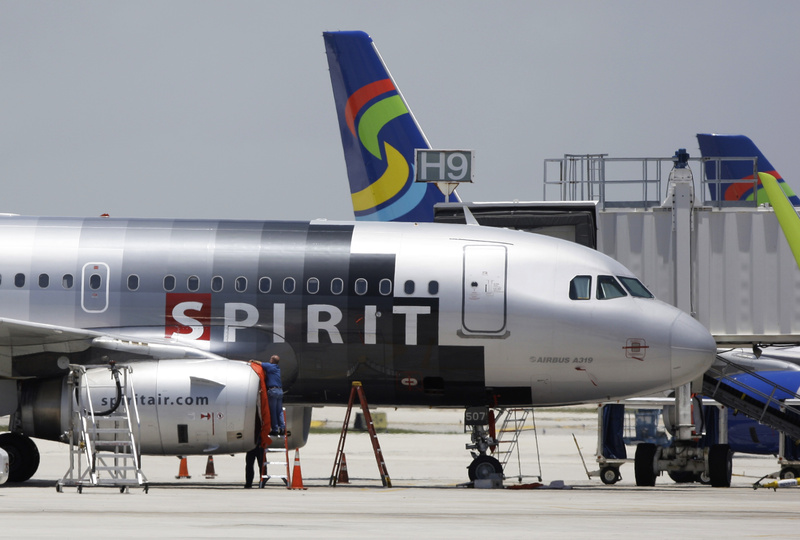 A Spirit Airlines airplane sits on the tarmac at Fort Lauderdale-Hollywood International Airport in Fort Lauderdale, Fla., in this file photo. A new fee on carry-on bags took effect on Sunday.