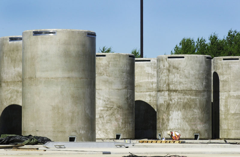 These are some of the 64 steel-lined concrete containers that make up the dry cask storage facility where spent fuel assemblies are stored at Maine Yankee in Wiscasset. The assemblies are sealed in stainless steel containers inside the casks.