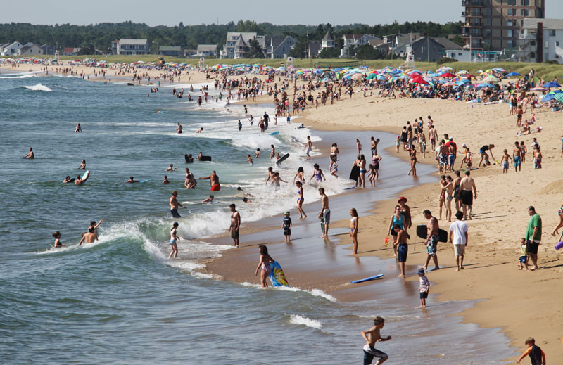 Swimmers and sunbathers are flocking back to Old Orchard Beach this year, after a poor showing last year with incessant rains and a bleak economy.