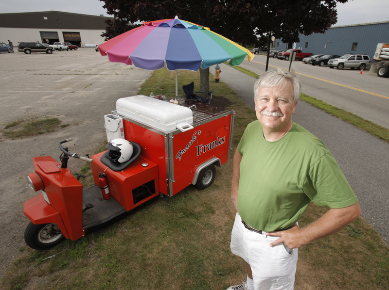 Frank Marston runs his hot dog cart, Frank's Franks, near Bug Light Park in South Portland. Marston started selling hot dogs this year in the cart that he adapted from a Cushman truckster. Marston says the design of the cart centered around the biggest cooler he could find.