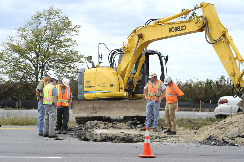 Maine Department of Transportation workers repair a sinkhole on the northbound passing lane of I-295 before Tukey's Bridge in Portland.