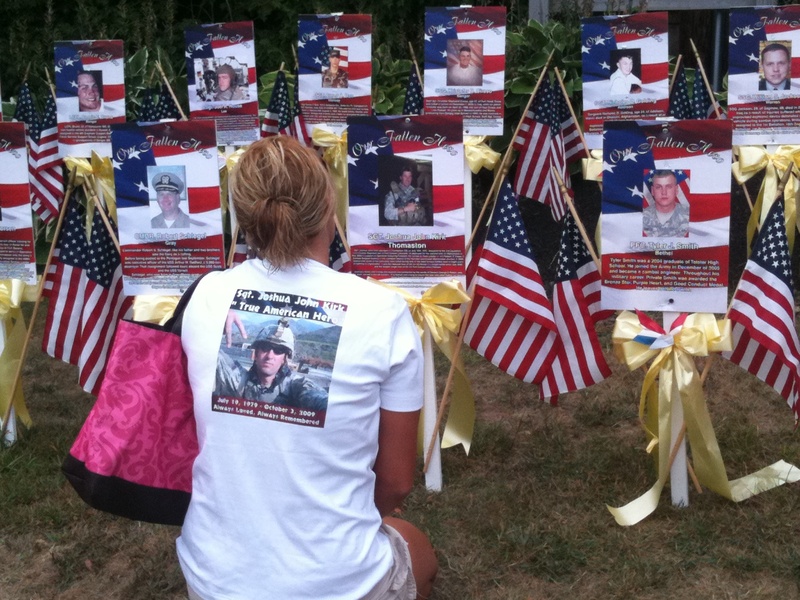 Elizabeth Fulton, whose brother died in Afghanistan, kneels before markers at Veterans’ Park in Ogunquit today before the Run for the Fallen, a noncompetitive run from Ogunquit to Portland to commemorate soldiers who have died since the Sept. 11, 2001 terrorist attacks.