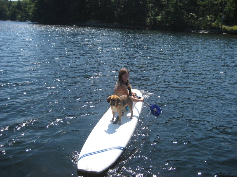 Abigail Matlack and Pancho Villa of Camden, the defending champion in the Boatyard Dog Trials, practice surfboard skills for the Aug. 15 contest.