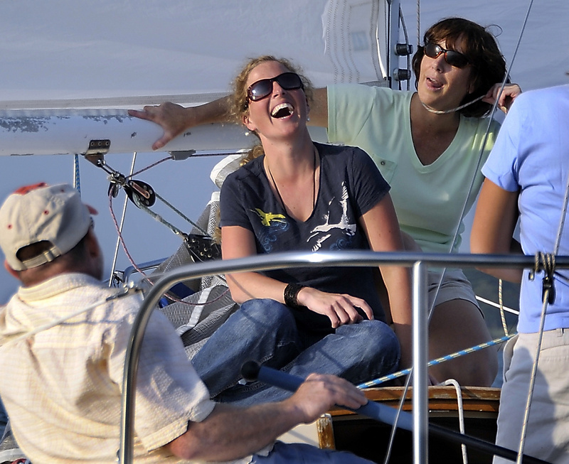 Shannon Bryan is entertained by crew member Shelly Paules, who jokingly demonstrates one of the dangers of sailing.
