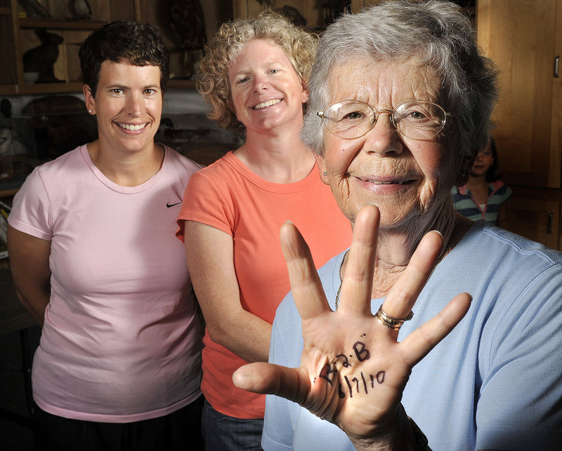 Della Hitchcox, 80, marked her palm as a reminder of this year's Beach to Beacon 10K Road Race, which she plans to run with her two daughters, Jennifer Hitchcox, left, and Susan Gallo.