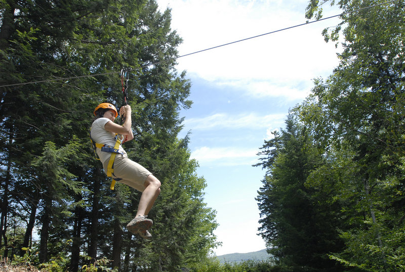 Sunday River's director of communications, Darcy Liberty, glides down a zip line.