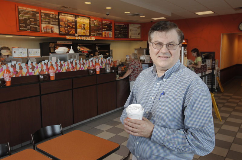 Ed Wolak, who owns 70 Dunkin’ Donuts franchises in New England and New York, as well as a donut factory, stands at the shop on Gray Road in Falmouth.