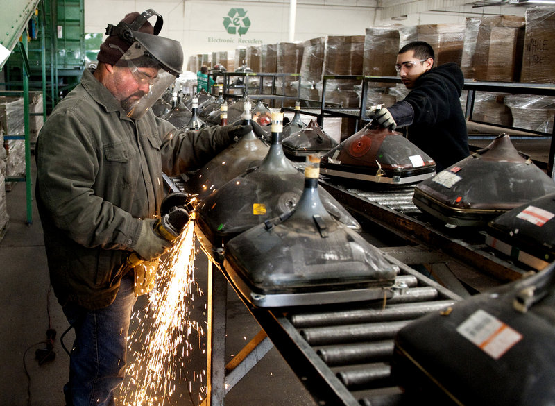 Rudy Chavez, an employee at Electronic Recyclers International, cuts into a monitor at the company’s facility in Fresno, Calif. For all its problems, the California law has been successful at recycling millions of castoffs each year.