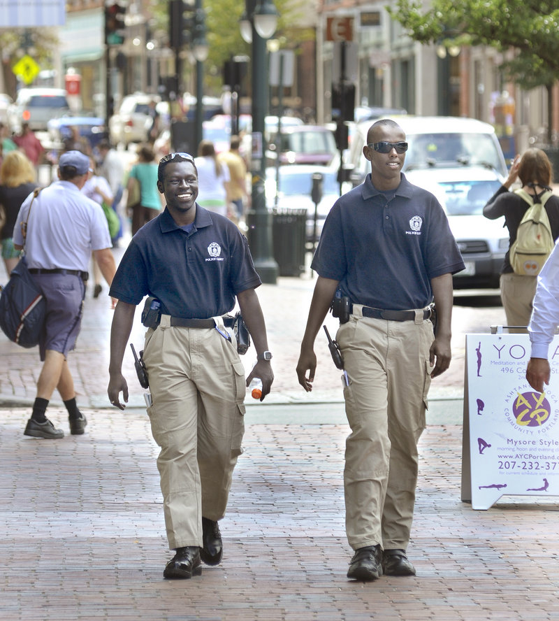 Portland police cadets Ater Ater, left, and Iman Ali patrol Congress Street in Portland on Friday. The cadets, who are interested in law enforcement careers, serve as intermediaries between police and the community.