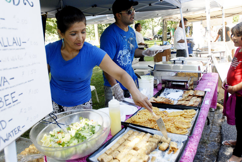 Hooria Majeed, originally of Kabul, Afghanistan, and now of Portland, serves Afghan baklava during the Festival of Nations Saturday. Majeed has a private catering business, specializing in Afghan, Middle Eastern and Greek cuisine.
