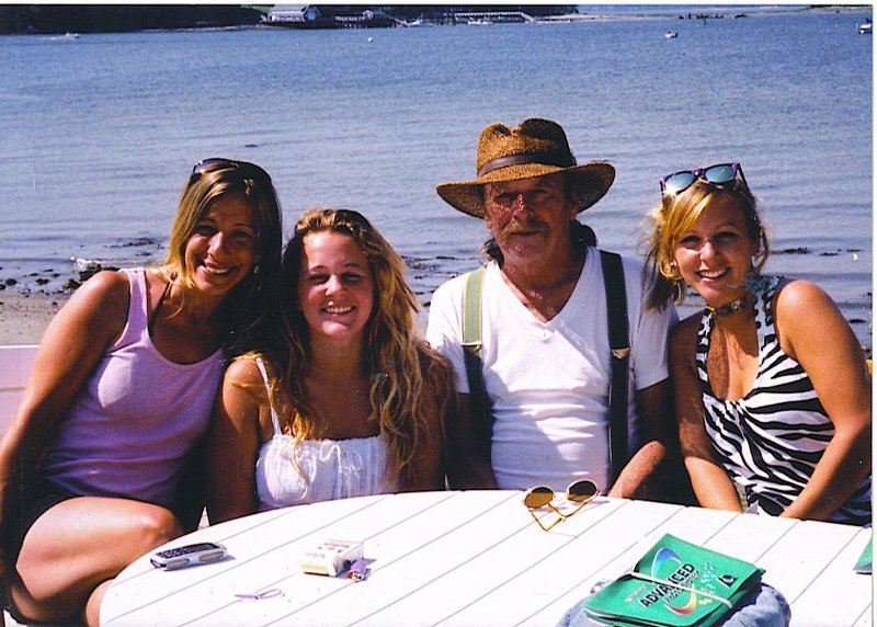 Chris Tuttle and his three daughters, from left, Amy Pelletier, Maggie Tuttle and Celia Tuttle, hang out at the beach.