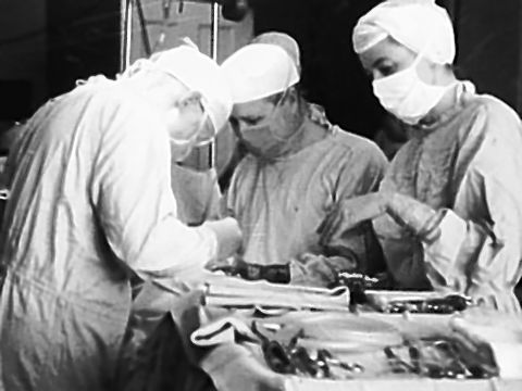 The Associated Press Dr. William Mac Vane, center, assists Dr. Emerson Drake with the first open heart surgery at Maine General Hospital in 1959.