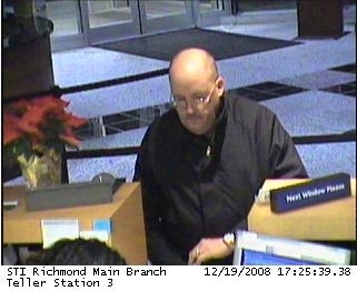 In a 2008 surveillance photo from the FBI, a robber dubbed the "Granddad Bandit" holds up a Richmond, Va., bank. Officials say it's very unusual that he doesn't conceal his face.