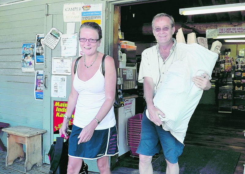 Linda Cteyr and Roch Tessier of East Angus, Quebec, head out of the Bayley’s Camping Resort store Monday with enough firewood for their stay at the Pine Point campground in Scarborough. Bringing in firewood from out of state is now illegal, to deter bringing in unwanted pests in the wood. The bag of hardwood firewood costs only $10 and is cut, seasoned and sold by Tom Bayley.