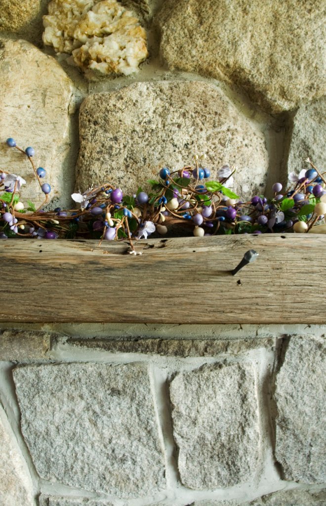 The wood for the mantel of the home’s fieldstone fireplace came from a shipwreck.