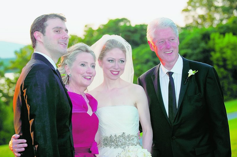 Marc Mezvinsky, left, poses with his mother-in-law, Hillary Clinton, his bride, Chelsea, and his father-in-law, former President Clinton, after the ceremony in Rhinebeck, N.Y., on July 31. Mezvinsky is Jewish; his wife is a Methodist.