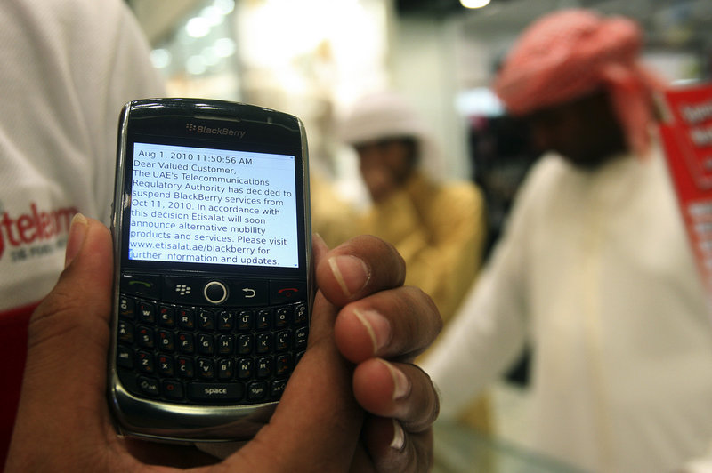 A BlackBerry user in Dubai, United Arab Emirates, displays a text message sent by his service provider on Thursday, notifying him of the suspension of BlackBerry messaging services,
