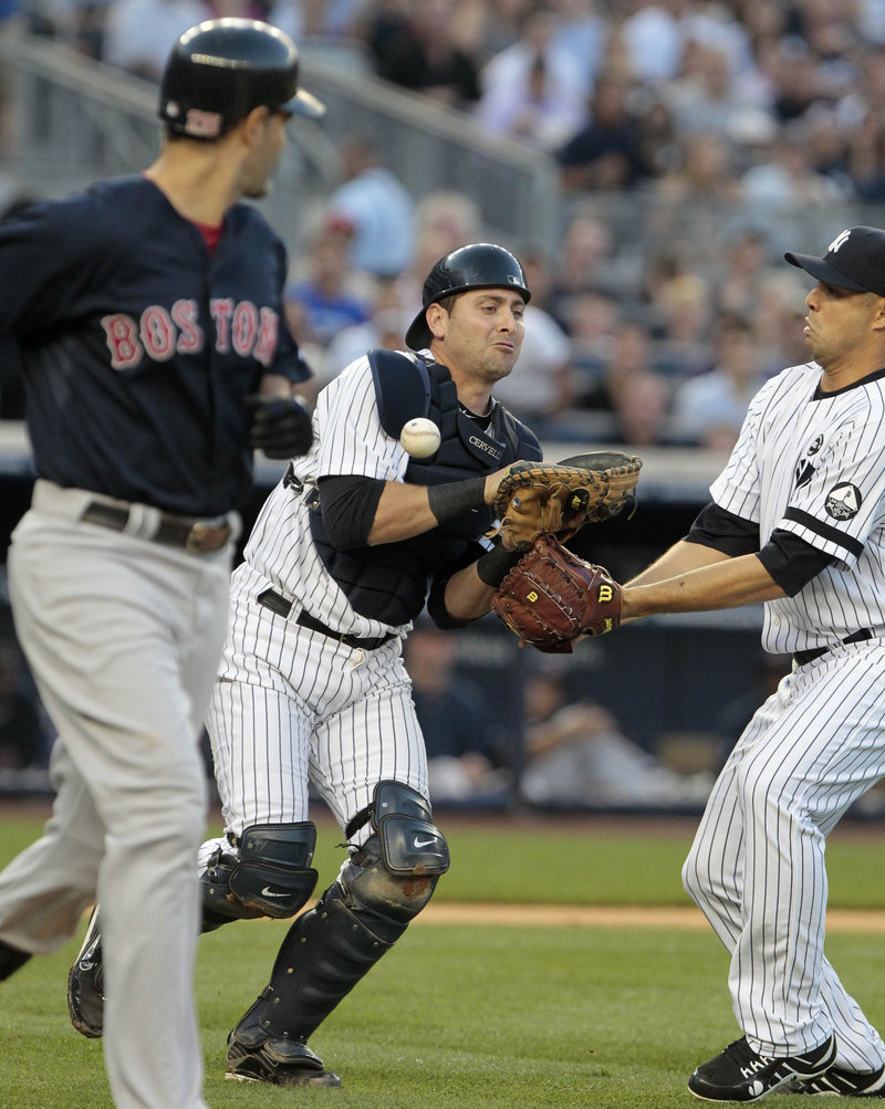 Yankees catcher Francisco Cervelli loses Mike Lowell’s pop fly in the second inning Friday night – a key play in a 6-3 victory for the Red Sox.