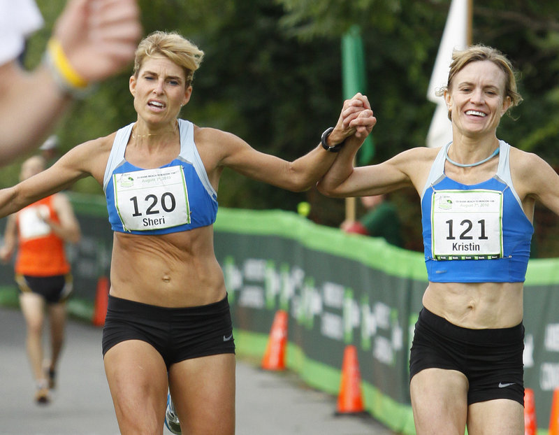 Sheri Piers, left, and Kristin Barry reach the finish line together. Officials named Barry the winner of the Maine women's division.