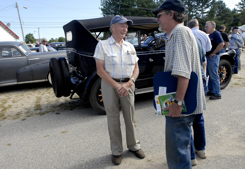 Auto collector Phil Hall talks with bidders prior to selling more than 100 cars on Saturday. Behind him is a 1924 Pierce-Arrow 7-seater that sold for $40,700.