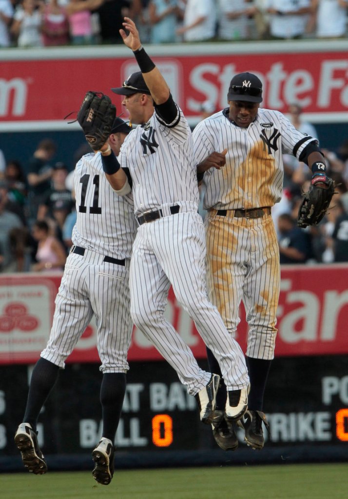 Celebration time for the New York Yankees after a 5-2 victory Saturday against the Boston Red Sox. Nick Swisher, center, Brett Gardner, left and Curtis Granderson do the hop.
