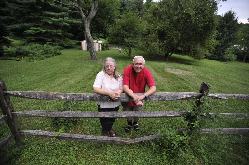 Paul Skidmore and his wife, Kathy, stand at their home in Finksburg, Md. Skidmore, 63, his unemployment benefits exhausted, plans to file this week for Social Security benefits, three years before full retirement age.