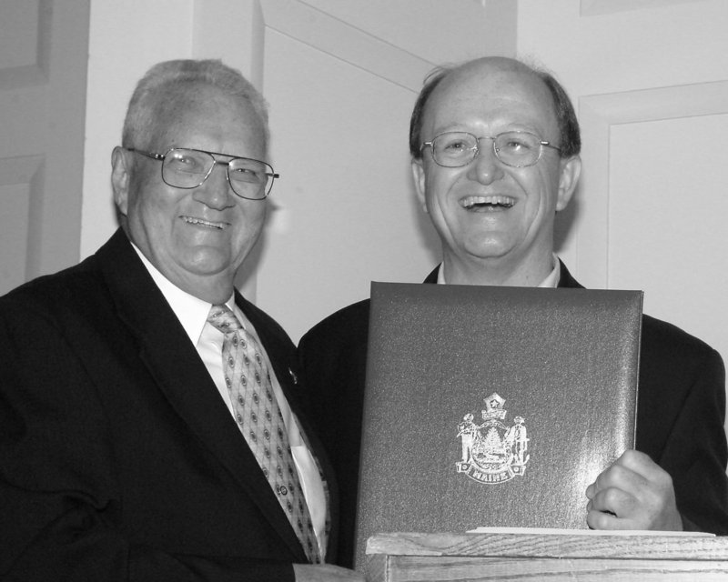 An unidentified legislator joins James E. Clark, left, as Clark is recognized by the Maine Legislature on his 80th birthday in 2003.