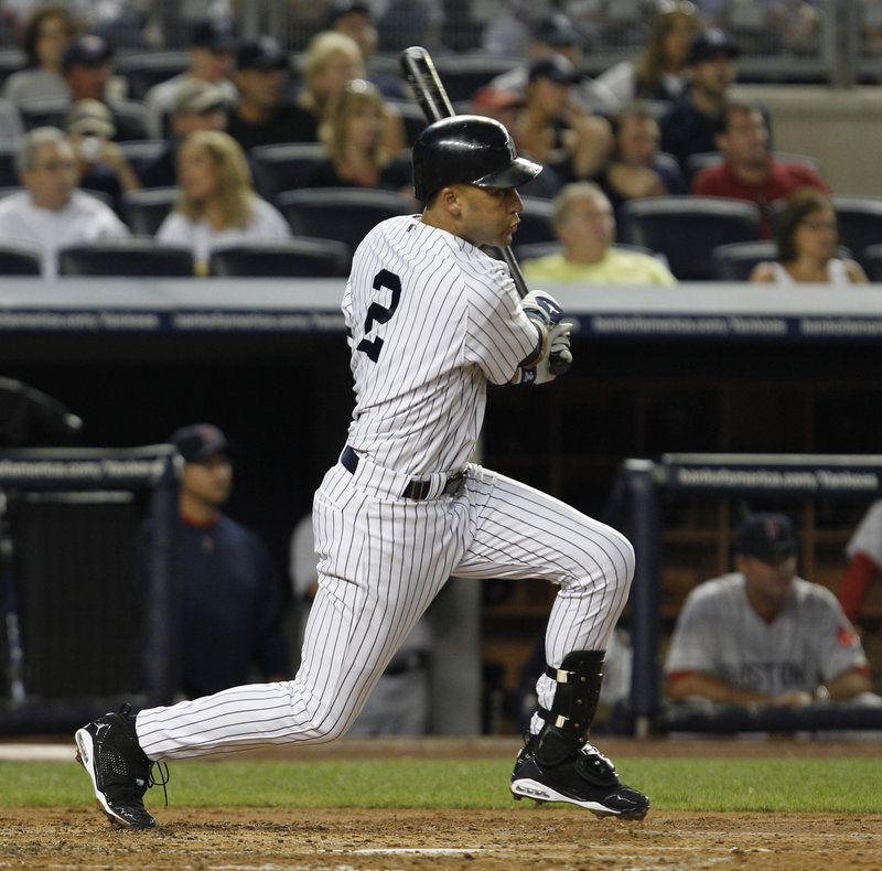 Yankees captain Derek Jeter follows through on his 2,874th career hit, an RBI single in the second inning that pushed him ahead of Babe Ruth into 38th place on baseball’s all-time list.