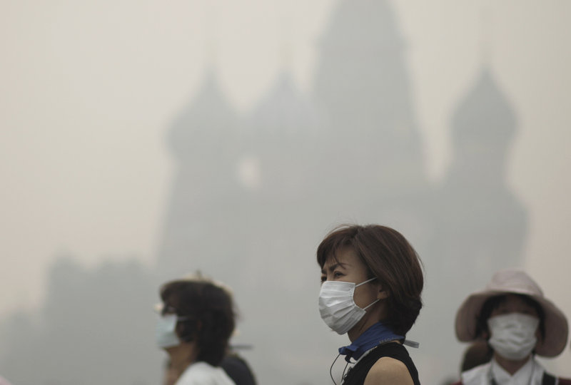 Tourists walk along Red Square in Moscow in a blanket of smog in 2014. China, Mexico, India and parts of Russia show how bad our environment could become.