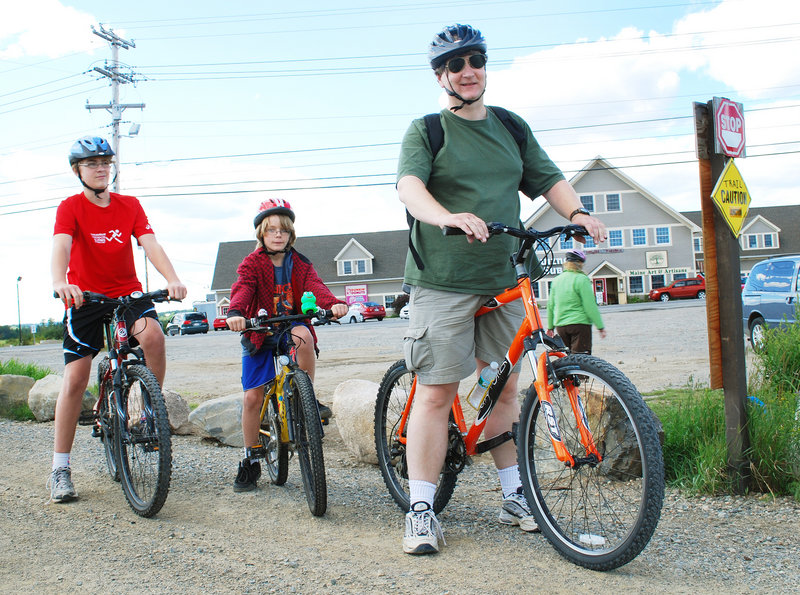 Alex Diehl and his sons Markus, left, and Fridrik prepare to bike the Down East Sunrise Trail from Machias. They are excited the trail will be extended to near Ellsworth this fall.