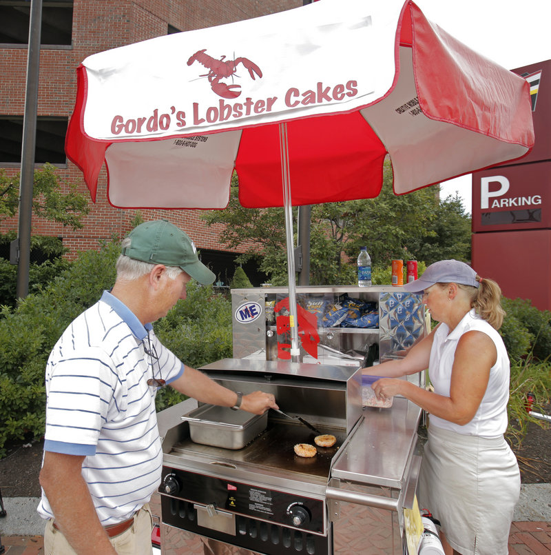 Gordon and Carolyn Smith started selling lobster cakes and lobster rolls from their cart on Commercial Street in Portland this summer. The 3 1⁄2-ounce lobster cakes are served hamburger-style.