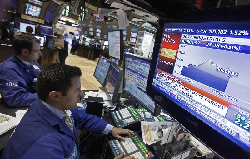 A monitor on the floor of the New York Stock Exchange shows the Fed Funds Rate and stock market data after the Federal Reserve’s decision Tuesday to buy government debt.