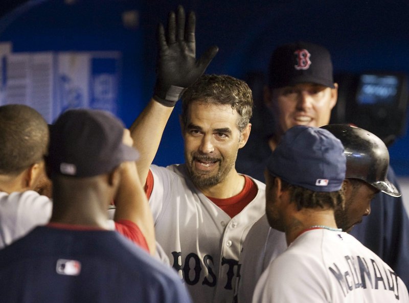 Mike Lowell celebrates his solo homer in the eighth inning Tuesday night in Toronto. The Red Sox defeated the Blue Jays, 7-5.