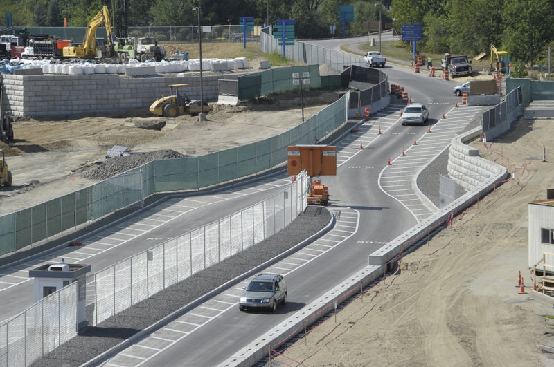 A median strip divides the access road into two sets of lanes, one set that will serve a new departure area and the other set to take drivers to a passenger pickup area.