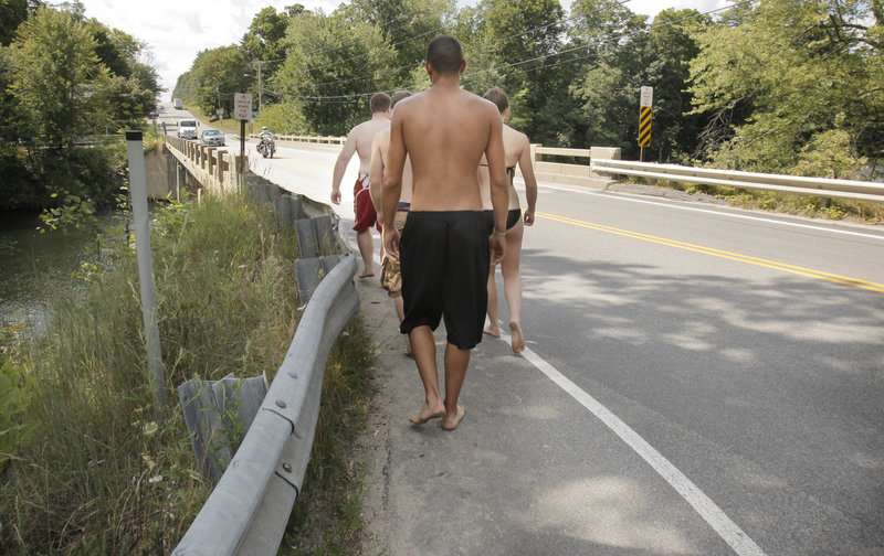 Youths return for another dive from the bridge. Last summer a swimmer was hit by a car and nearly killed while crossing the bridge to jump off. Buxton Police Chief Michael Grovo said there’s also a concern about drinking there. “Drinking adds fuel to the fire. The kids get more daring,” he said. “It’s a constant problem down there.”