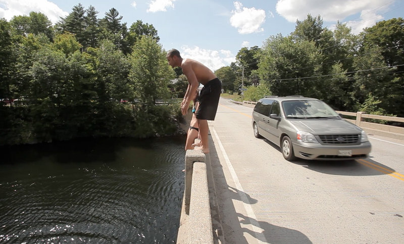 Young divers cool off by leaping into the Saco River from the Salmon Falls Bridge linking the York County towns of Hollis and Buxton.