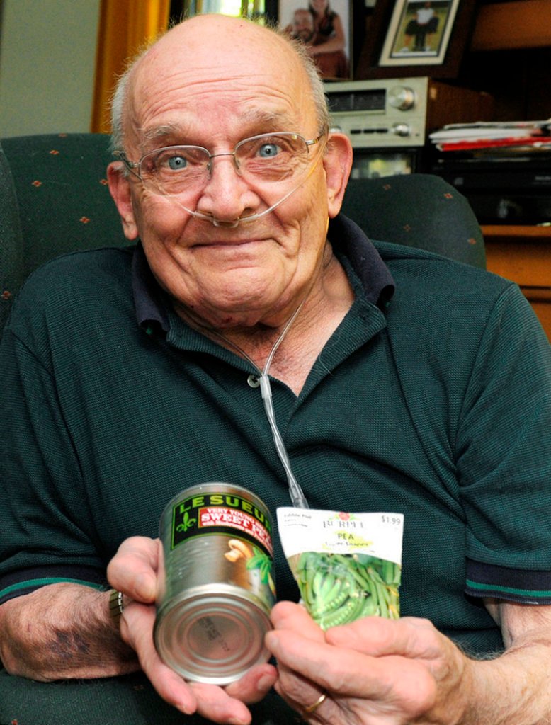 Ron Sveden, at home in Brewster, Mass., holds a can of peas and bag of pea seeds he received from friends after doctors discovered a pea growing in his lung.
