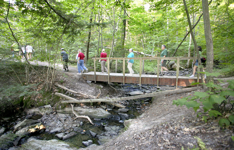 Hikers walk to the Presumpscot River Falls during the Walk Along the Presumpscot Trail Friday. The trail is part of more than 30 miles of trails opened to the public by Portland Trails in the past two decades.
