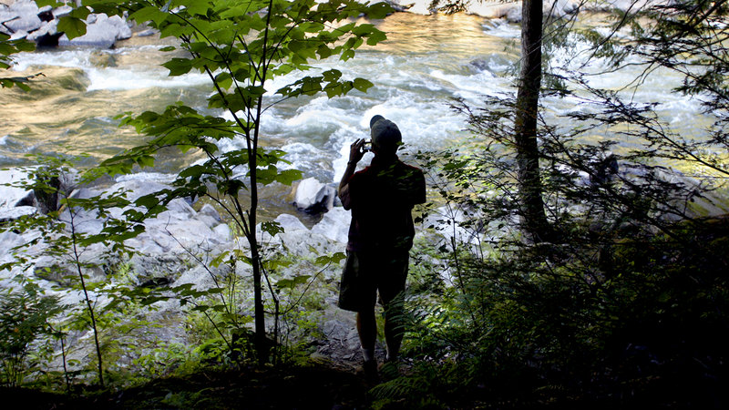 David Little of Portland photographs the Presumpscot River Falls during the Walk Along the Presumpscot Trail hosted by the Portland Trails as part of their Adventure Series in Portland on Friday.